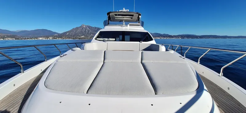 Nassara Yacht Photos Pics 2023 Azimut 78 yacht on calm sea with mountain backdrop.