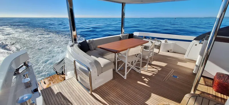 Nassara Yacht Photos Pics Luxury Azimut 78 yacht deck with seating, table, and ocean view, 2023 model.