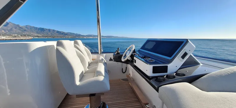 Nassara Yacht Photos Pics Helm of 2023 Azimut 78 yacht with ocean view and modern controls.
