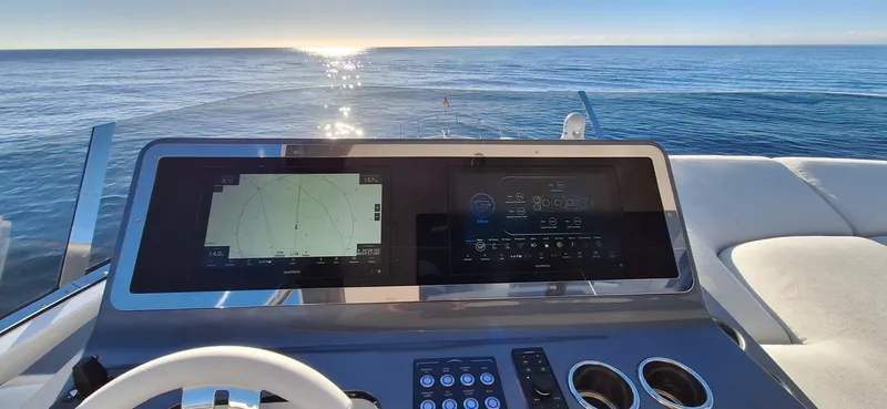 Nassara Yacht Photos Pics Cockpit view of 2023 Azimut 78 yacht with navigation screens, steering wheel, and ocean horizon.