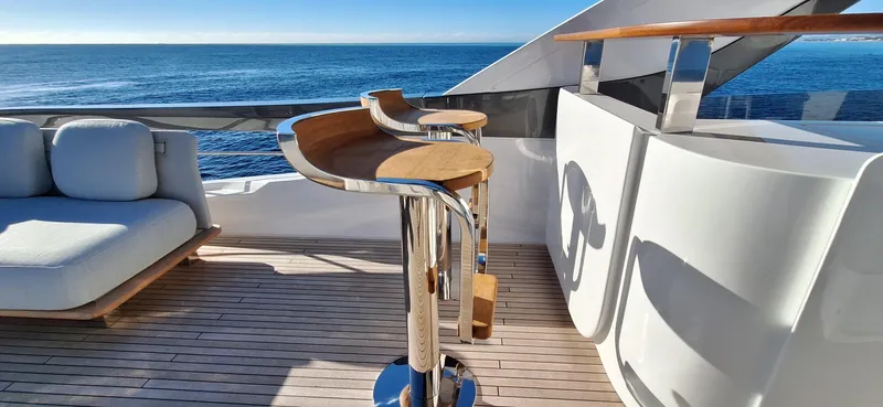 Nassara Yacht Photos Pics Luxurious 2023 Azimut 78 yacht deck with ocean view, featuring modern seating and bar area.