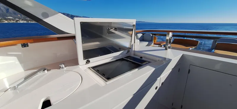 Nassara Yacht Photos Pics 2023 Azimut 78 yacht deck with open storage, overlooking the ocean.