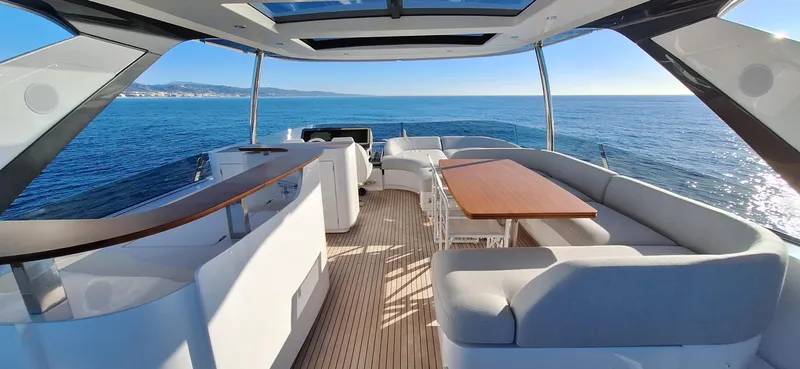 Nassara Yacht Photos Pics Luxurious 2023 Azimut 78 yacht interior with ocean view, featuring elegant seating and dining area.