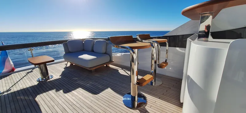 Nassara Yacht Photos Pics Luxurious 2023 Azimut 78 yacht deck with modern seating, ocean view, and sunny sky.