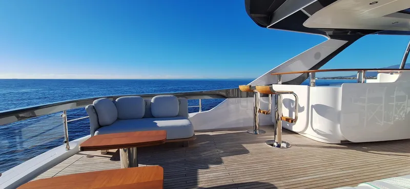 Nassara Yacht Photos Pics Luxurious 2023 Azimut 78 yacht deck with ocean view, featuring elegant seating and bar area.