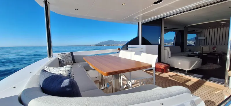 Nassara Yacht Photos Pics Luxurious 2023 Azimut 78 yacht with elegant outdoor seating and ocean view.