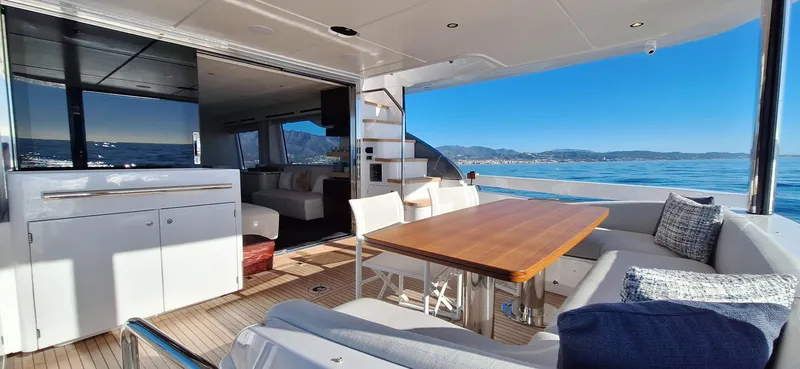 Nassara Yacht Photos Pics Luxurious 2023 Azimut 78 yacht interior with ocean view, featuring elegant dining area.