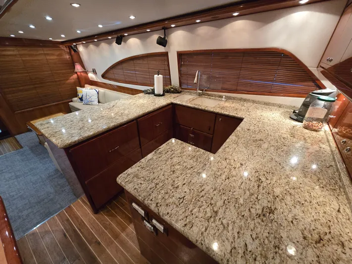 Dock Side Yacht Photos Pics Luxurious kitchen interior of 2007 Bertram 570 Convertible yacht with granite countertops.