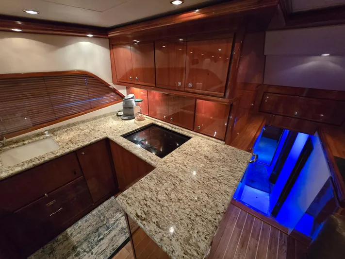 Dock Side Yacht Photos Pics Luxurious kitchen interior of 2007 Bertram 570 Convertible yacht with granite countertops.
