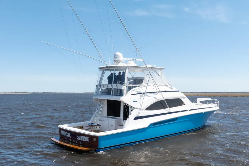 Dock Side Yacht Photos Pics 2007 Bertram 570 Convertible yacht cruising on open water under clear skies.