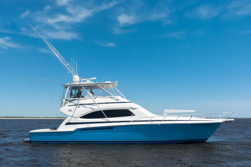 Dock Side Yacht Photos Pics 2007 Bertram 570 Convertible yacht on open water under clear blue sky.