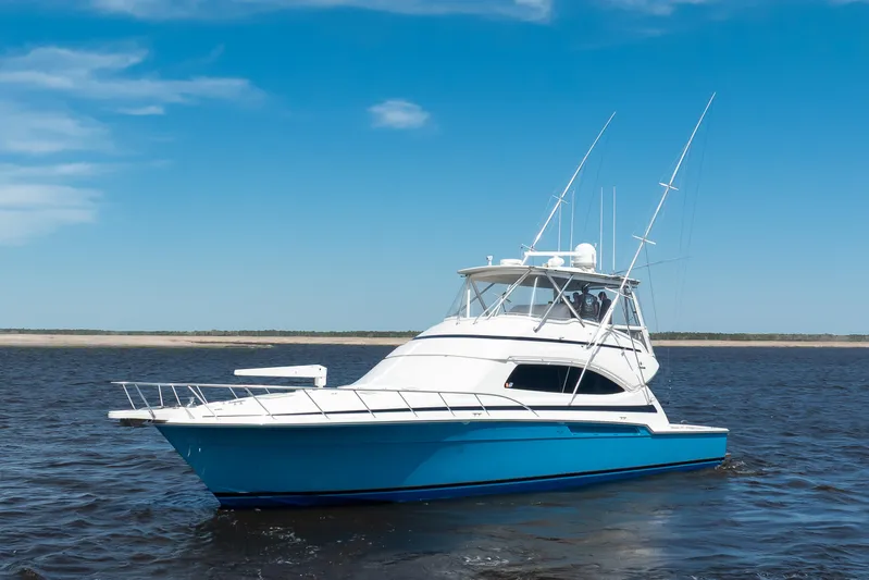 Dock Side Yacht Photos Pics 2007 Bertram 570 Convertible yacht on open water under clear blue sky.