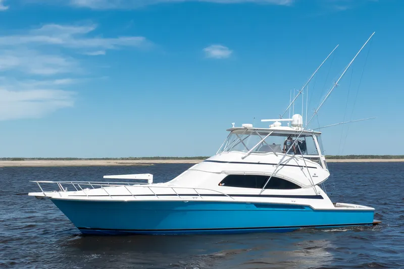 Dock Side Yacht Photos Pics 2007 Bertram 570 Convertible yacht on open water under clear blue sky.