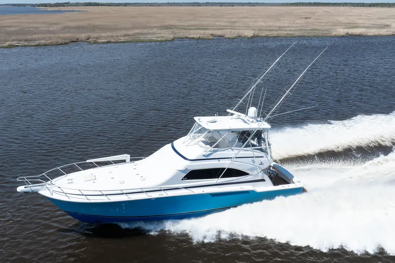 Dock Side Yacht Photos Pics 2007 Bertram 570 Convertible yacht cruising on open water.