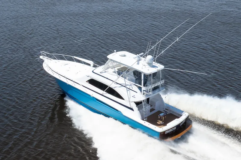 Dock Side Yacht Photos Pics 2007 Bertram 570 Convertible yacht cruising on open water, showcasing sleek design and performance.