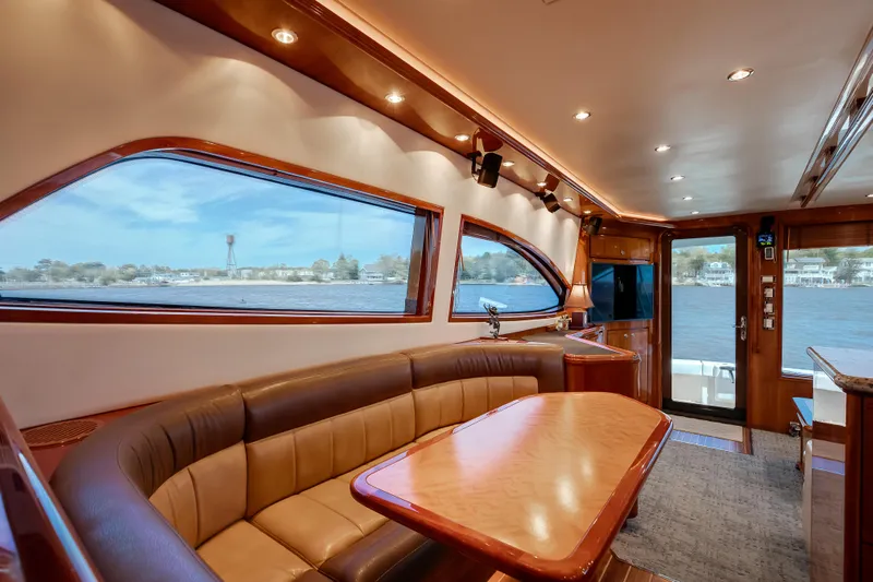 Dock Side Yacht Photos Pics Luxurious interior of 2007 Bertram 570 Convertible yacht with elegant seating and panoramic windows.