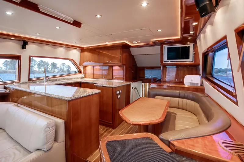 Dock Side Yacht Photos Pics Luxurious interior of a 2007 Bertram 570 Convertible yacht with elegant wood finishes.