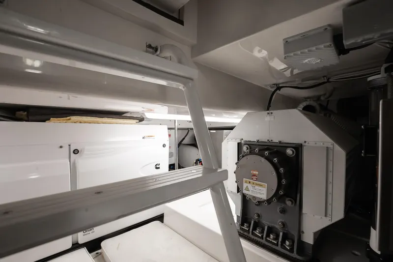 Dock Side Yacht Photos Pics Engine room of a 2007 Bertram 570 Convertible yacht, featuring machinery and equipment.