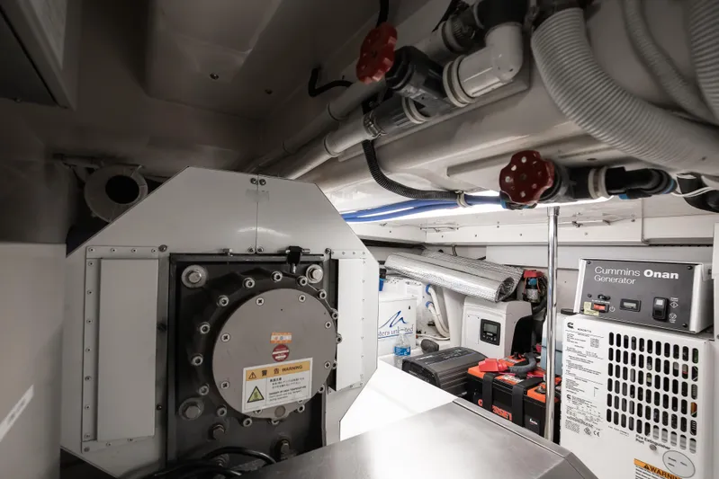 Dock Side Yacht Photos Pics Engine room of 2007 Bertram 570 Convertible with Cummins Onan generator and mechanical components.