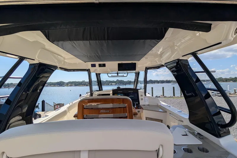  Yacht Photos Pics Interior view of 2024 Boston Whaler 350 Realm boat, overlooking serene waterfront.