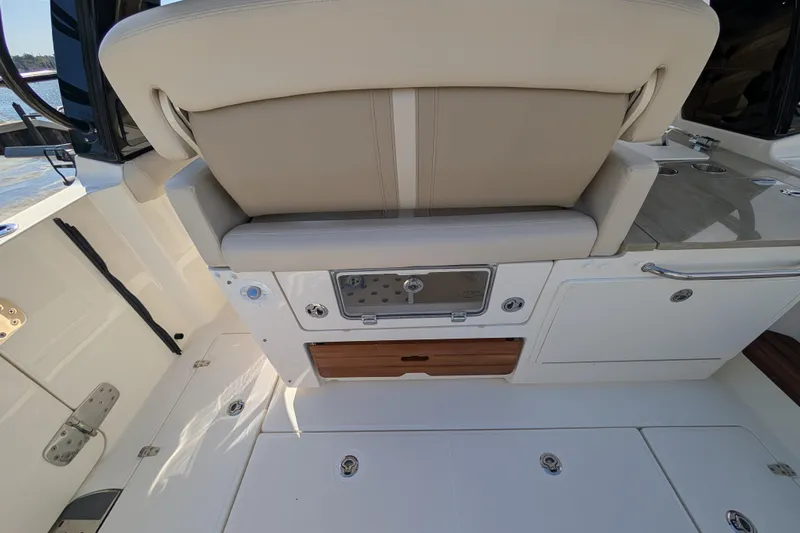  Yacht Photos Pics 2024 Boston Whaler 350 Realm interior, featuring a luxurious seating area and storage compartments.