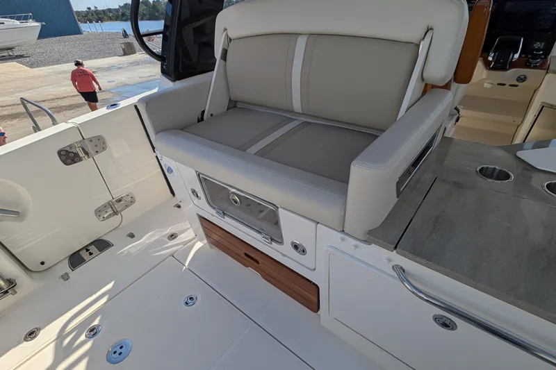  Yacht Photos Pics 2024 Boston Whaler 350 Realm interior with seating and storage features.