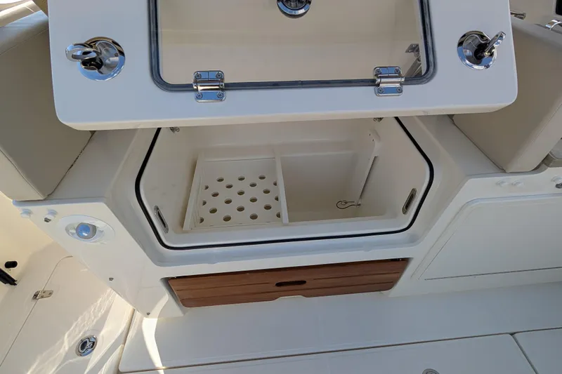  Yacht Photos Pics 2024 Boston Whaler 350 Realm boat storage compartment with open hatch and drainage system.