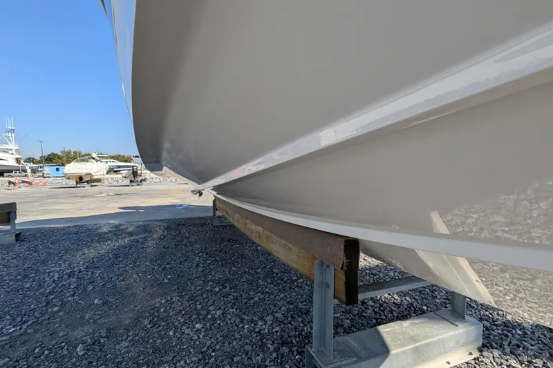  Yacht Photos Pics 2024 Boston Whaler 350 Realm boat hull on a stand, outdoor setting.