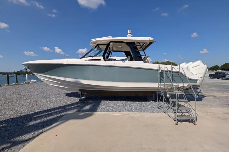  Yacht Photos Pics 2024 Boston Whaler 350 Realm boat on display with clear blue sky background.