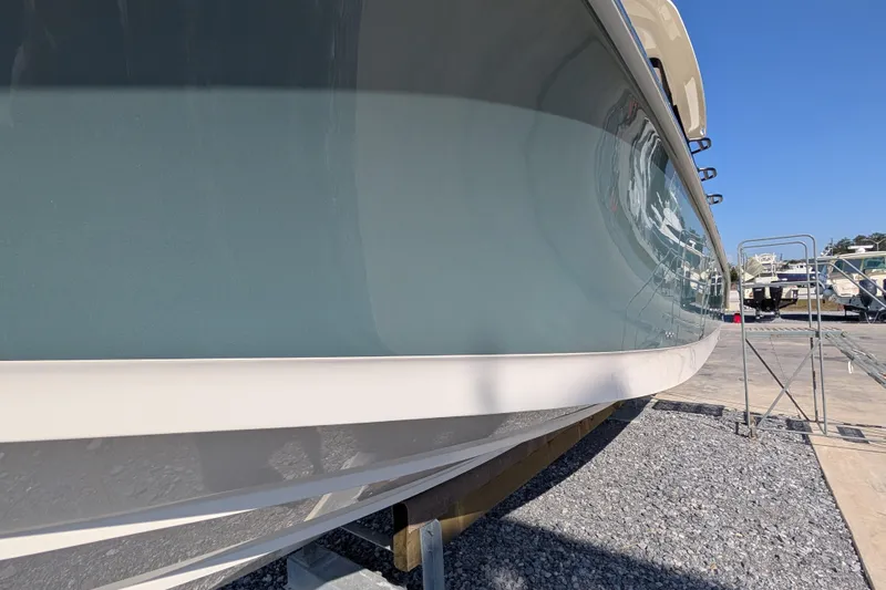  Yacht Photos Pics 2024 Boston Whaler 350 Realm boat hull in a marina setting.
