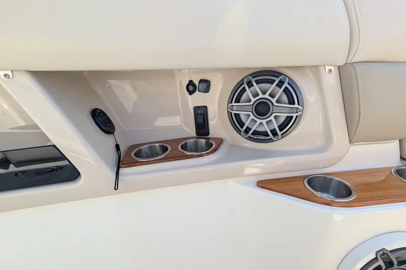  Yacht Photos Pics 2024 Boston Whaler 350 Realm interior with speaker, cup holders, and control panel.