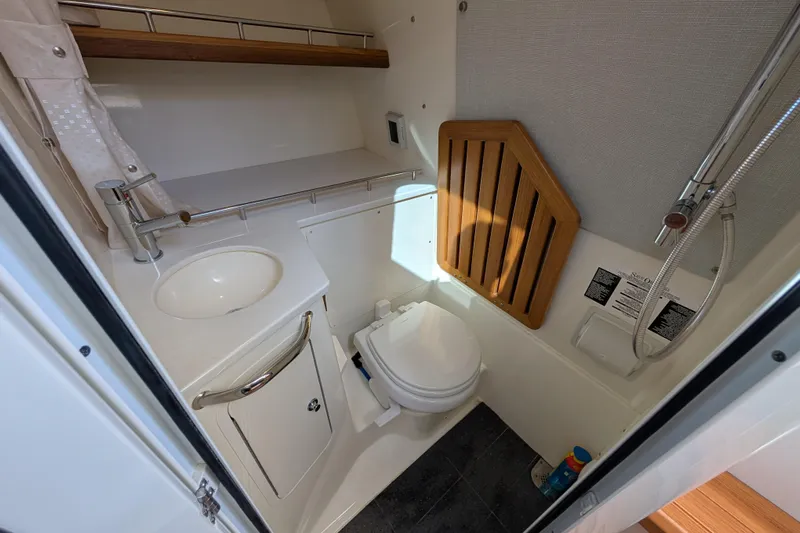 Yacht Photos Pics 2024 Boston Whaler 350 Realm boat bathroom with sink, toilet, and shower.