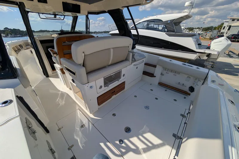  Yacht Photos Pics 2024 Boston Whaler 350 Realm boat interior with seating and deck view.