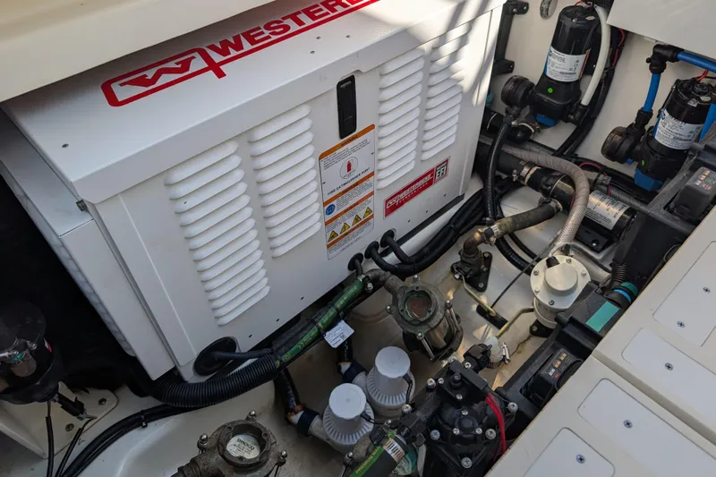  Yacht Photos Pics Engine compartment of 2024 Boston Whaler 350 Realm with Westerbeke generator and various components.