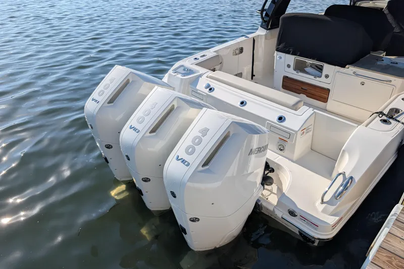  Yacht Photos Pics 2024 Boston Whaler 350 Realm with triple Mercury outboard engines on calm water.