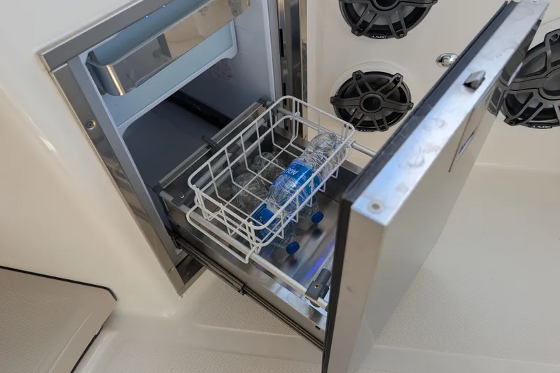  Yacht Photos Pics Open cooler drawer on 2024 Boston Whaler 350 Realm, with water bottles inside.