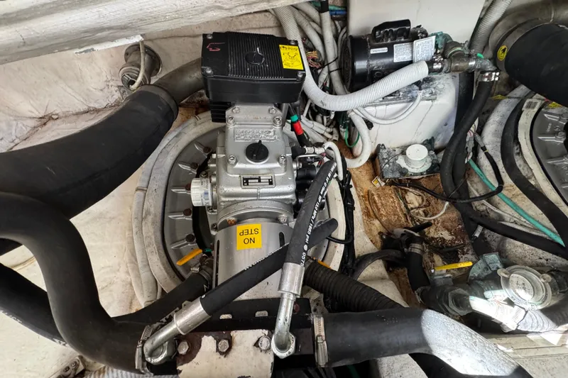  Yacht Photos Pics Engine compartment of a 2008 Tiara Yachts 3900 Sovran, showcasing mechanical components and hoses.