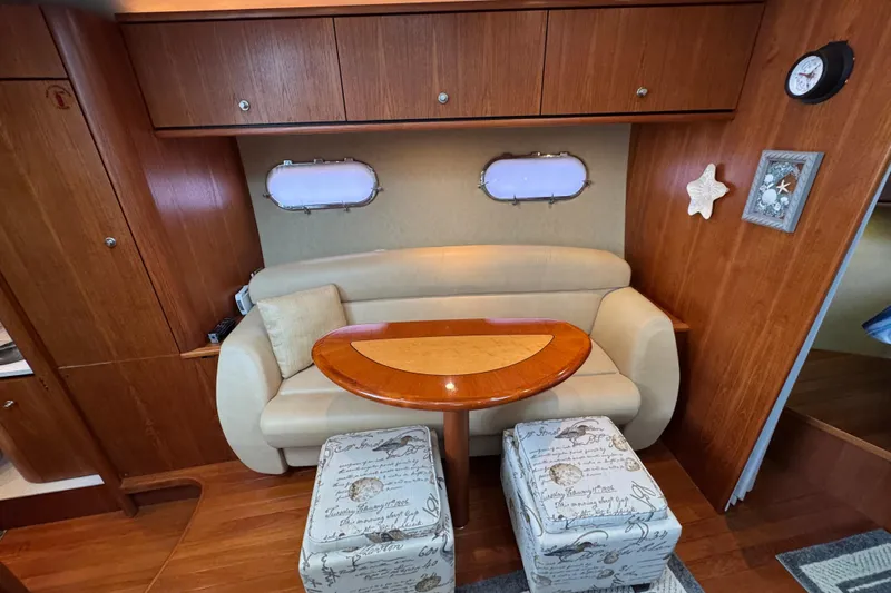  Yacht Photos Pics 2008 Tiara Yachts 3900 Sovran interior with cozy seating, wooden table, and nautical decor.