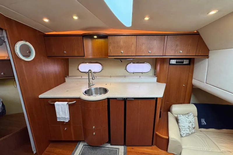  Yacht Photos Pics 2008 Tiara Yachts 3900 Sovran interior with wooden cabinetry and compact kitchen area.