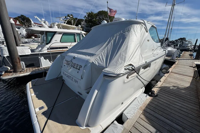  Yacht Photos Pics 2008 Tiara Yachts 3900 Sovran docked, covered, with American flag in background.