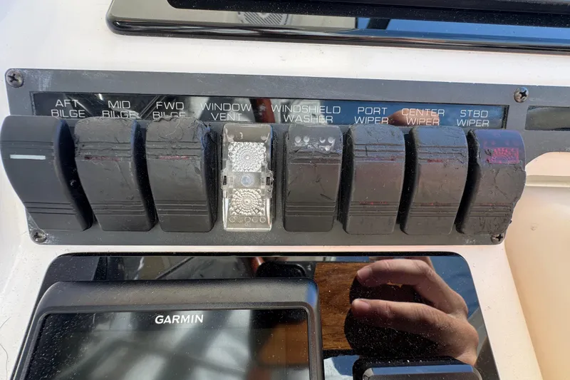  Yacht Photos Pics Control panel of a 2008 Tiara Yachts 3900 Sovran with labeled switches and Garmin display.