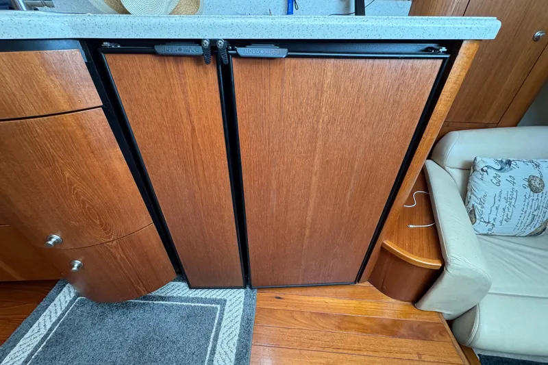  Yacht Photos Pics 2008 Tiara Yachts 3900 Sovran interior with wooden cabinetry and compact refrigerator.