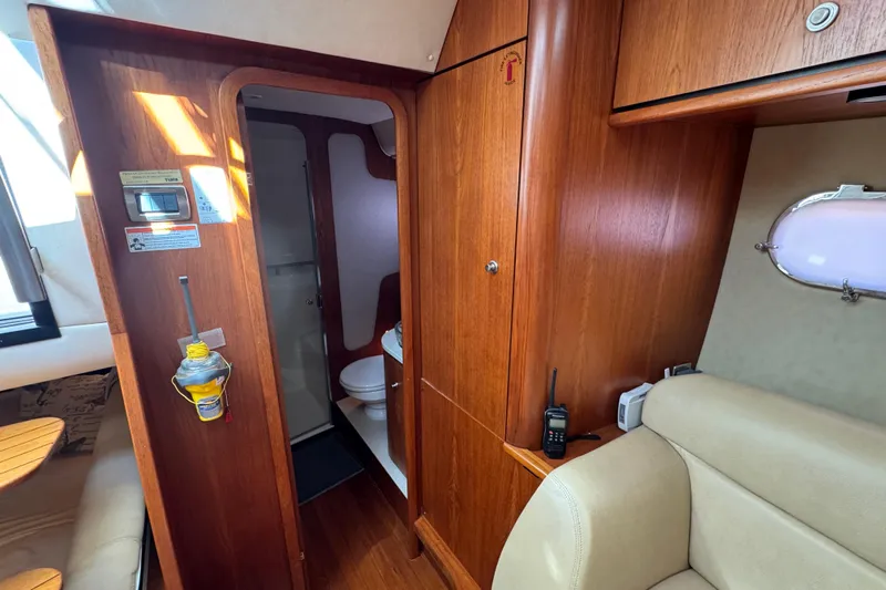 Yacht Photos Pics Interior of 2008 Tiara Yachts 3900 Sovran, featuring wood cabinetry and a compact bathroom.