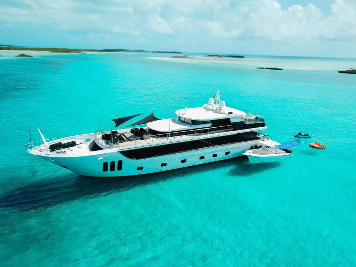  Yacht Photos Pics Luxurious 2010 Custom WHS Marine yacht in turquoise waters, surrounded by jet skis.