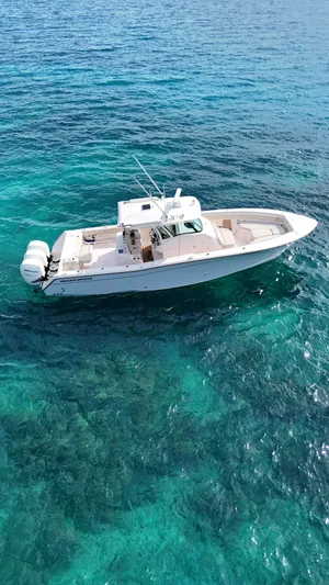  Yacht Photos Pics Grady-White Canyon 366 boat, 2013 model, cruising on clear turquoise waters.