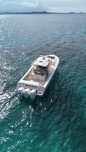  Yacht Photos Pics Grady-White Canyon 366 boat cruising on clear ocean waters, 2013 model.