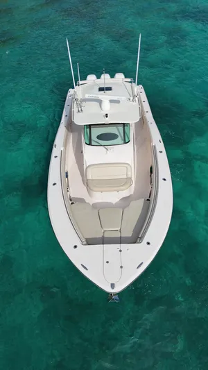  Yacht Photos Pics Aerial view of 2013 Grady-White Canyon 366 boat on clear turquoise water.