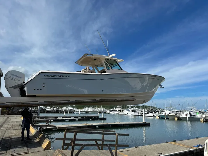  Yacht Photos Pics 2013 Grady-White Canyon 366 boat at marina, clear sky background.