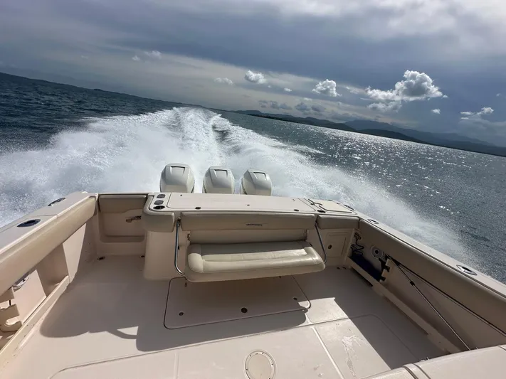  Yacht Photos Pics 2013 Grady-White Canyon 366 boat speeding on open water, leaving a wake behind.