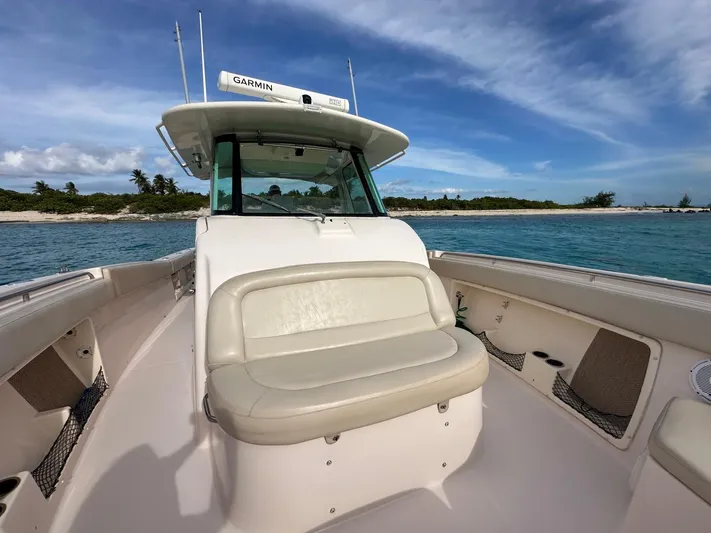  Yacht Photos Pics 2013 Grady-White Canyon 366 boat on clear blue water near a tropical island.